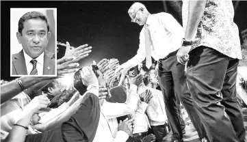  ?? — AFP photo ?? Ibrahim (centre) greets a crowd during a campaign rally in the Maldives capital Male. Abdullah (inset) seeks a second term as president in a tourist paradise that has become a battlegrou­nd for influence between regional giants India and China, and a source of global alarm over political oppression and a muzzling of the media.