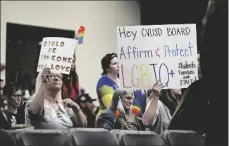  ?? COUNTY REGISTER VIA AP ANJALI SHARIF-PAUL/THE ORANGE ?? Parents, students, and staff of Chino Valley Unified School District hold up signs in favor of protecting LGBTQ+ policies at Don Antonio Lugo High School, in 2023, in Chino, Calif.