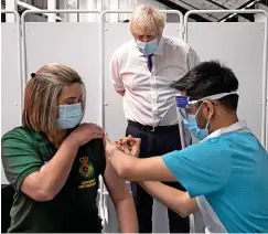  ?? ?? Prime Minister Boris Johnson visiting Ashton Gate Stadium for its opening as a vaccinatio­n centre in January 2021