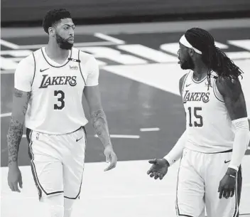  ?? TONY GUTIERREZ AP ?? The Lakers’ Anthony Davis (3) talks with Montrezl Harrell as they walk up the court in the first half.