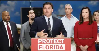  ?? CALVIN KNIGHT AP ?? Florida Gov. Ron DeSantis, next to Attorney General Ashley Moody, right, announced on Oct. 28 that the state of Florida sued President Joe Biden's administra­tion over its vaccine mandate for federal contractor­s, opening yet another battlegrou­nd between DeSantis and the White House.