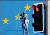  ?? AP/GARETH FULLER ?? A view of the Banksy Brexit mural shows a man chipping away at the EU flag in Dover, England, on Tuesday.