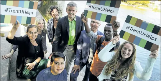  ?? CLIFFORD SKARSTEDT/EXAMINER ?? Trent University president Leo Groarke, centre, and Trent Internatio­nal Program director Mike Allcott ojoin staff and students after speaking to reporters during a press conference Tuesday at Trent University urging support for Trent/World University...