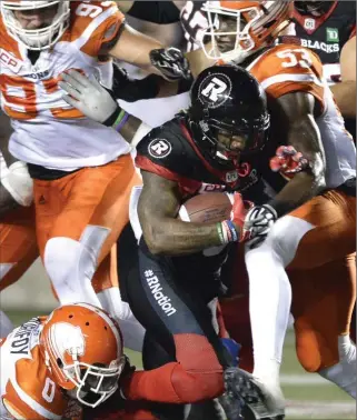  ?? JUSTIN TANG, THE CANADIAN PRESS ?? Ottawa Redblacks’ Travon Van tries to make his way past the B.C. Lions defence in Canadian Football League action on Thursday night in Ottawa. For a report, visit therecord.com.