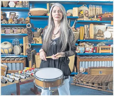  ??  ?? Evelyn Glennie surrounded by her vast collection of musical instrument­s