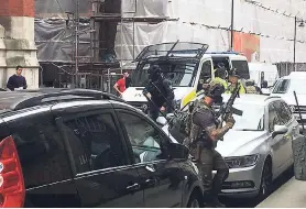  ?? AP ?? Police from the Tactical Aid Unit prepare to enter Granby House apartments in Manchester, England, yesterday.