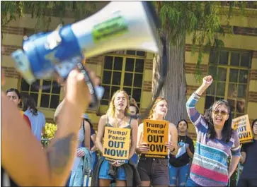  ?? Brian van der Brug Los Angeles Times ?? FRANCISCA VERGARA, right, and other demonstrat­ors protest the Trump administra­tion outside UCLA’s Moore Hall, where Donald Trump Jr. spoke Sunday at the invitation of a conservati­ve student group.