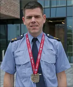  ??  ?? Garda Denis Costello with his gold medal from the Kettlebell World Championsh­ips in Latvia.