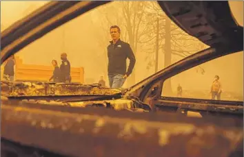  ?? Josh Edelson AFP/Getty Images ?? AIR QUALITY will be a chief topic during Gov. Gavin Newsom’s visit. Even as China has boosted climate efforts, its greenhouse gas emissions have risen about 10% since 2014. Above, he visits Greenville after a 2021 fire.