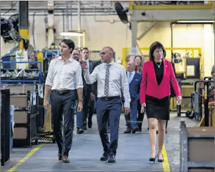  ?? CP PHOTO ?? Prime Minister Justin Trudeau tours Metrican Stamping Co. with Joe Bosco, VP of Engineerin­g and Pam Damoff, MP for Oakville North-burlington (right), Thursday.