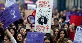  ?? — AFP ?? Demonstrat­ors hold placards as they protest during a one day strike to defend women’s rights on Internatio­nal Women’s Day in Madrid and ( below) Washington Square Park on Thursday.