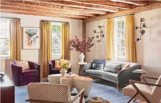  ?? ?? The living room carries the home’s historic character with rough-hewn ceiling beams and wide-plank wood flooring.