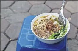  ??  ?? A bowl of Vietnamese bun cha, a popular street food in Hanoi