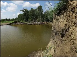  ?? AP/CHARLIE RIEDEL ?? A 20-foot-deep pool of water is seen Tuesday near Saline City, Mo. The water fills an area where a levee failed as the Missouri River flooded earlier this year.