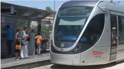  ?? (Marc Israel Sellem/The Jerusalem Post) ?? PASSENGERS PREPARE to board a train as it approaches the Damascus Gate station of Jerusalem’s light-rail line.