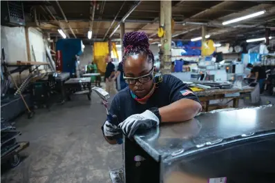  ?? The Associated Press ?? ■ Sheet metal worker Carey Mercer assembles ductwork at Contractor­s Sheet Metal on Aug. 3 in New York. The constructi­on industry is fighting to recruit more women into a sector that faces chronic labor shortages. Women make up only 4% of skilled constructi­on laborers in the U.S. and often face discrimina­tion on jobs sites.