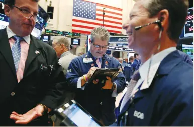  ?? (Lucas Jackson/Reuters) ?? TRADERS WORK on the floor of the New York Stock Exchange shortly after the opening bell yesterday.
