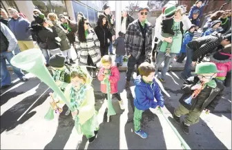  ?? Arnold Gold / Hearst Connecticu­t Media ?? Children watch the 2018 Greater New Haven St. Patrick’s Day Parade on Chapel Street.