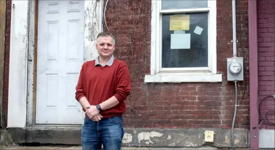  ?? Nate Guidry/Post-Gazette ?? Real estate investor Aaron Chaney stands outside one of the properties he is fixing up in the Strip District on March 31.