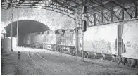  ?? JERRY JACKSON/BALTIMORE SUN ?? A southbound freight train enters the Howard Street Tunnel at Mount Royal Station. A project to renovate the tunnel to accommodat­e double-stacking may be delayed by cost overruns associated with the Purple Line light rail project in suburban D.C.