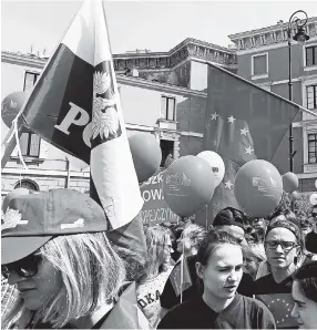  ??  ?? Young people carry flags and balloons during the yearly Schumann Parade supporting European Union ideas, in Warsaw, Poland, yesterday.