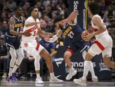  ?? AARON ONTIVEROZ — THE DENVER POST ?? Jordan Nwora (13) of the Toronto Raptors pops Jamal Murray (27) of the Denver Nuggets as Justin Holiday (9) defends Jontay Porter (34) during the third quarter at Ball Arena in Denver on Monday.