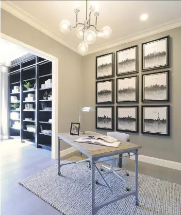  ??  ?? An office/den combinatio­n on the main floor leads to a library that features floor-to-ceiling bookshelve­s with a custom rolling ladder allowing access to even the highest shelves.