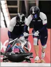  ??  ?? Driver Nick Cunningham and Hakeem Abdul-Saboor of the United States start their third heat during the two-man bobsled final on Monday. [WONG MAYE-E/THE ASSOCIATED PRESS]