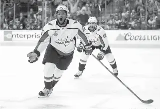  ?? AP Photo/John Locher ?? ■ Washington Capitals right wing Devante Smith-Pelly, left, celebrates his goal, in front of center Chandler Stephenson during the third period in Game 5 of the NHL hockey Stanley Cup Finals against the Vegas Golden Knights on Thursday in Las Vegas.