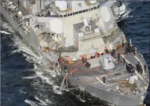  ?? The Associated Press ?? USS FITZGERALD: The damaged USS Fitzgerald is seen Saturday off Yokosuka, near Tokyo, Japan, after the destroyer collided with a merchant ship. The U.S. Navy says the bodies of sailors who went missing in the collision between the USS Fitzgerald and a...
