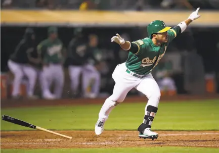  ?? Ben Margot / Associated Press ?? Ramon Laureano celebrates after his first big-league hit drives in the winning — and only — run in the 13th inning.