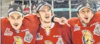  ?? VINCENT ETHIER/QMJHL ?? Mitchell Balmas of Sydney, centre, is shown with Acadie-Bathurst Titan teammates on Sunday.