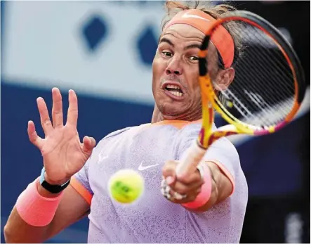  ?? afp ?? Back in the groove: rafael Nadal returns the ball to Flavio Cobolli during the Barcelona Open at the real Club de Tenis on Tuesday. —