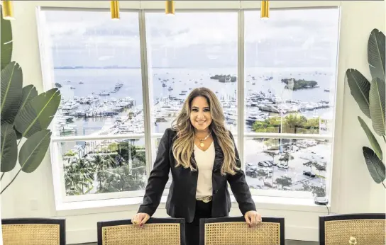  ?? PEDRO PORTAL pportal@miamiheral­d.com ?? Lissette Calderon, CEO of Neology Life Developmen­t Group, can enjoy the view of the Coconut Grove waterfront from her office’s conference room.