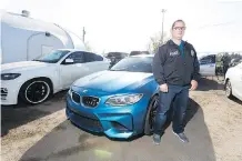  ?? GREG SOUTHAM ?? Det. Mark Kassian with several of the recovered vehicles from a VIN cloning operation. Eight mostly high-end vehicles were seized,