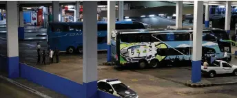  ?? — AFP photo ?? View of the bus (left) where a gunman held passengers hostage at the Novo Rio bus terminal in Rio de Janeiro, Brazil.