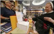  ?? ANDREW MEDICHINI — THE ASSOCIATED PRESS ?? Copies of Pope Francis' latest encyclical letter on the environmen­t, “Laudate Deum,w” are on sale in a bookshop in Rome on Wednesday.