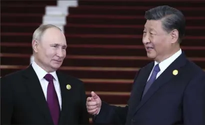  ?? Sergey Savostyano­v/Sputnik, Kremlin via AP ?? Russian President Vladimir Putin, left, and Chinese President Xi Jinping in Beijing, China.