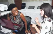  ??  ?? Adella Campbell (left) and Jiang Duo of the Embassy of the People’s Republic of China in Jamaica having a good laugh.