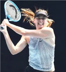  ?? — AFP photo ?? Sharapova hits a return during a practice session ahead of the Australian Open tennis tournament in Melbourne in this Jan 19 file photo.