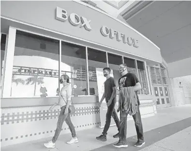  ?? JOHN MCCALL/SOUTH FLORIDA SUN SENTINEL PHOTOS ?? Idalmis, Justin and Antonio Valdes walk into Regal Westfork Stadium 13 on Wednesday in Pembroke Pines.