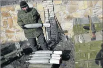  ?? Picture: EPA/ALEXANDER ERMOCHENKO ?? OFFENSIVE: A pro-Russian separatist holds a shell as he takes position not far from the Ukrainian town of Debaltseve.