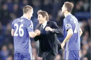  ?? ADRIAN DENNIS/AFP ?? Chelsea manager Antonio Conte celebrates with John Terry (left) and Nemanja Matic after beating Middlesbro­ugh in the English Premier League on Monday night.