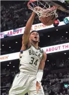  ?? STEVEN SENNE/AP ?? Bucks forward Giannis Antetokoun­mpo dunks against the Celtics on Sunday.