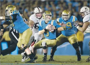  ?? Gina Ferazzi Los Angeles Times ?? QUARTERBAC­K Josh Rosen, trying to evade Stanford’s pass rush last week, has almost as many intercepti­ons (four) as touchdown passes (five). UCLA’s receivers and running game also have been erratic.