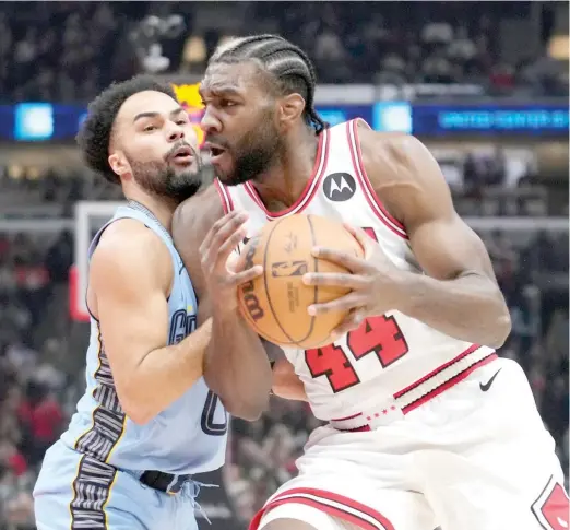  ?? CHARLES REX ARBOGAST/AP ?? Bulls forward Patrick Williams works against Grizzlies guard Jacob Gilyard during the first half Saturday at the United Center.