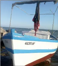  ??  ?? A fishing boat waits on a beach near Sfax, Tunisia. The nation is a fascinatin­g blend of white sand beaches, green flowering plains, wild deserts, date palm tree oases and ancient cities.