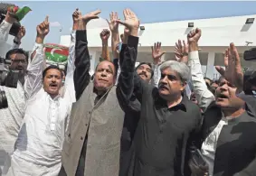  ?? ANJUM NAVEED/AP ?? Lawmakers and supporters of the Pakistan Tehreek-e-Insaf party chant slogans in favor of their leader, Prime Minister Imran Khan, on Sunday outside the National Assembly in Islamabad, Pakistan.