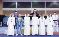  ??  ?? Gabriel Arges (centre) poses with the officials during the presentati­on ceremony of the Abu Dhabi Grand Slam Jiu-jitsu World Tour.