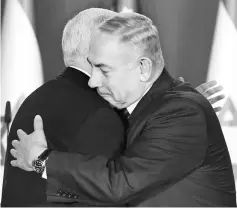  ??  ?? Pence (left) and Netanyahu hug in the Prime Minister’s residence in Jerusalem. — AFP photo